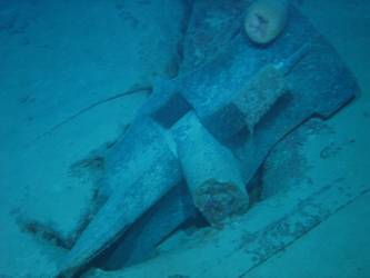 Stbd anchor embedded in steel plate from ship's side in debris field